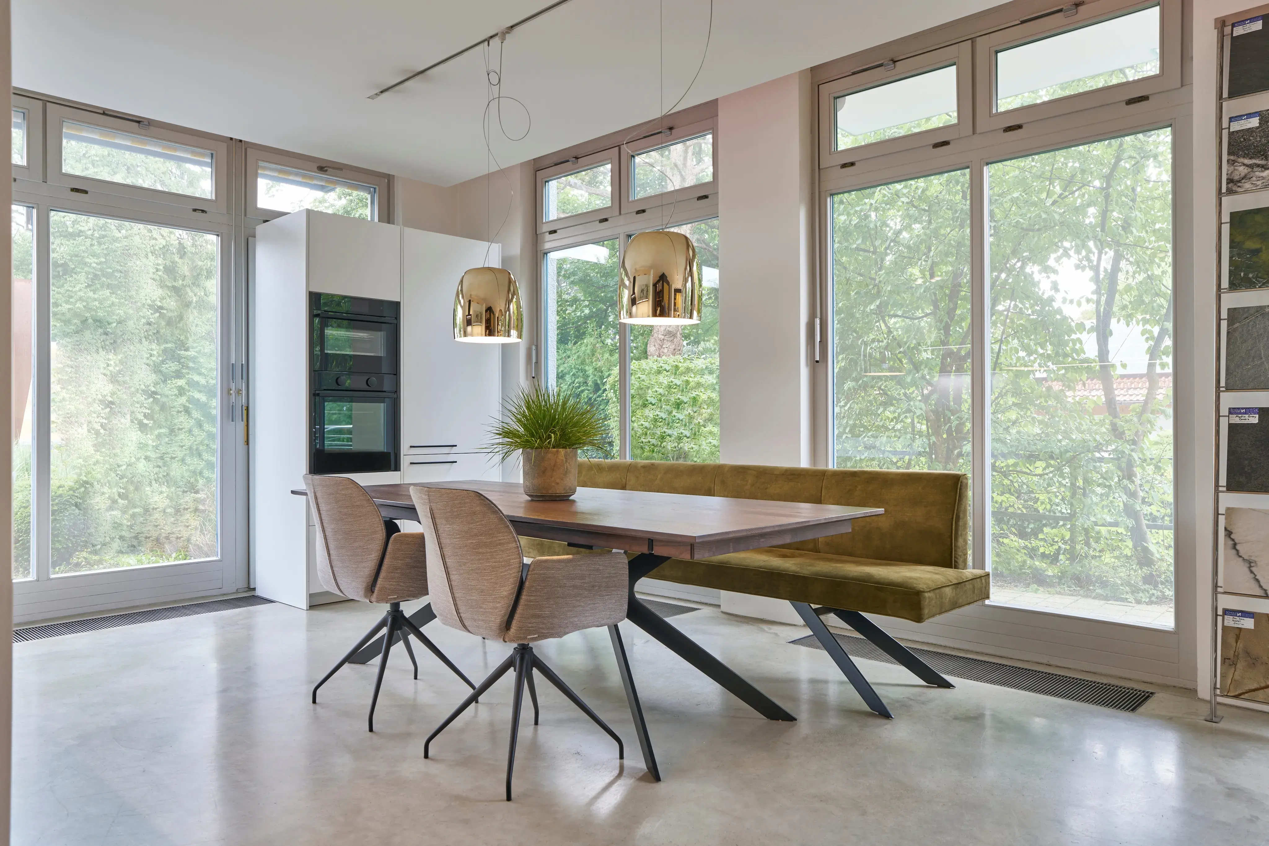 Moderner Essbereich mit Holztisch, Stühlen, Bank und großen Fenstern.