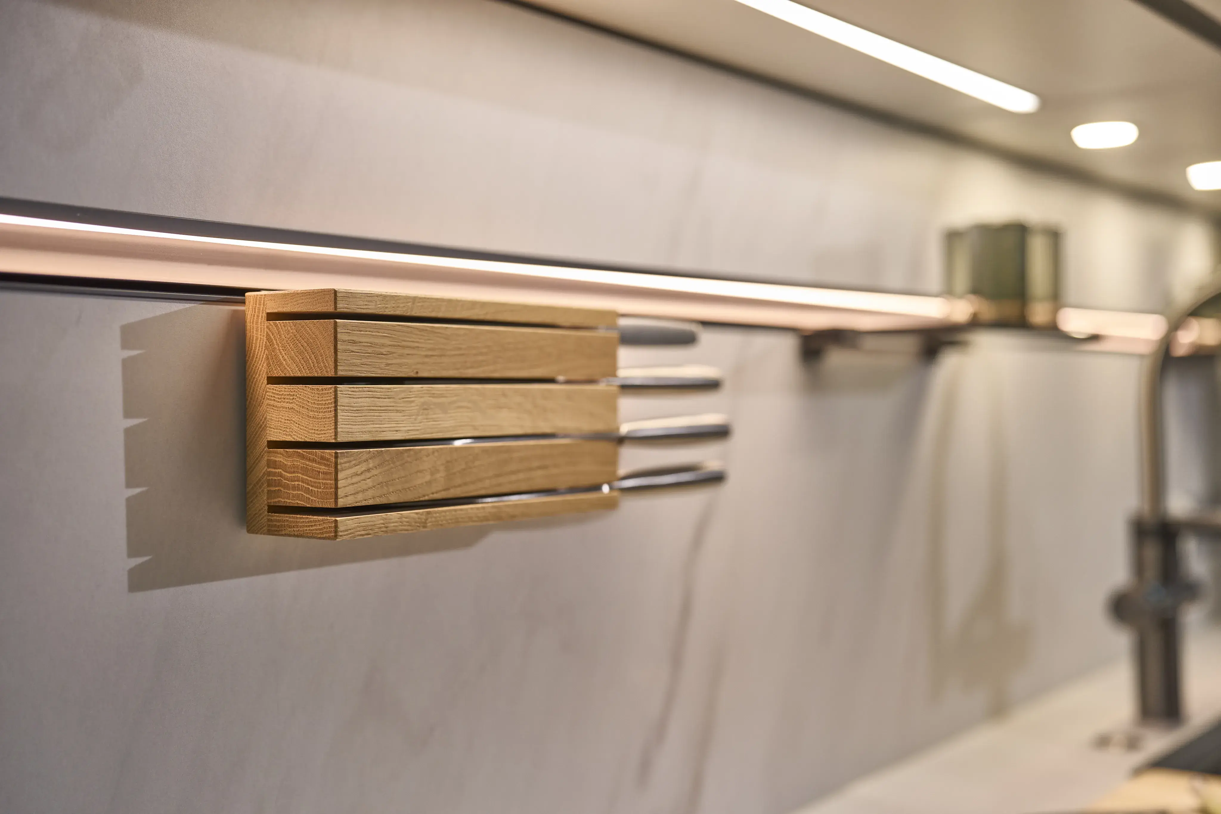 Magnetische Messerleiste mit vier Messern an einer modernen Küchenwand.